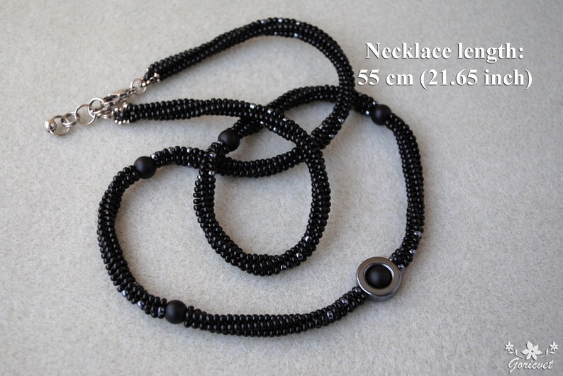 May include: Black beaded necklace with a silver clasp and a black hematite pendant. Necklace length: 55 cm (21.65 inch)