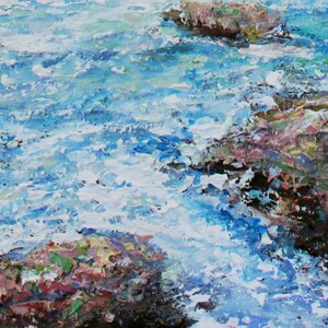 May include: A close-up of a painting depicting a rocky shoreline with blue water crashing against the rocks. The water is painted with thick, textured strokes, creating a sense of movement and energy. The rocks are painted in shades of brown, pink, and green, with hints of white and yellow.