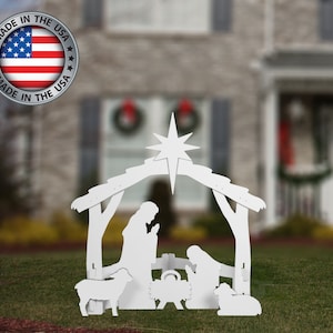 May include: White wooden outdoor Christmas nativity scene with a star, a manger, a shepherd, Mary, Joseph, and two sheep.