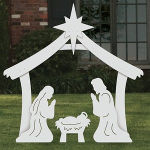May include: White wooden cutout of a nativity scene with a star on top. The scene includes Mary, Joseph, and baby Jesus in a manger.