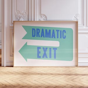 May include: A white framed poster with a green and blue arrow pointing to the right. The arrow has the text "Dramatic Exit" in blue letters.