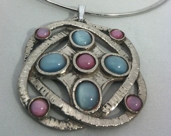 vintage silver metal torque necklace and Celtic knot pendant with pink and blue cat's eye cabochons