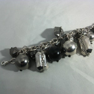 vintage bracelet with chain and charms in metal and various materials