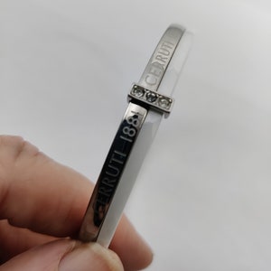 signed CERRUTI 1881 bangle bracelet in silver metal, white ceramic and rhinestones