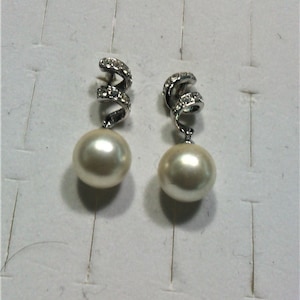 vintage fancy earrings with white pearls on metal