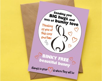 May include: A greeting card with a lilac background and a brown envelope. The card features a black and white bunny illustration and text that reads "Sending you BIG hugs and lots of bunny love."