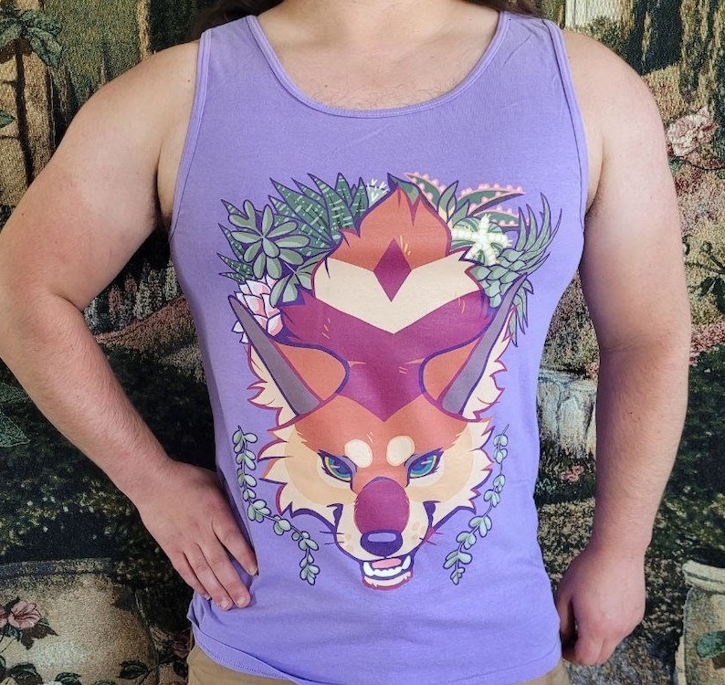 May include: Purple tank top with a graphic of a red fox with green plants around its head. The fox has a white diamond on its forehead and a white stripe down its nose.