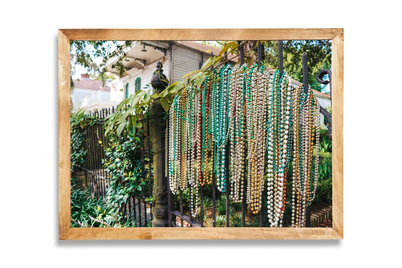 mardi gras beads on fence