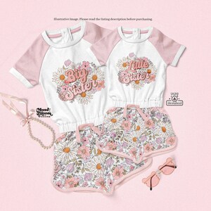 May include: Two matching white and pink children's outfits. One top says "Big Sister" and the other says "Little Sister", both surrounded by floral designs. The shorts have a floral pattern. Accessories include sunglasses and a pearl necklace.