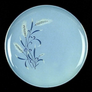 May include: A light blue ceramic dinner plate with a white and blue wheat design.