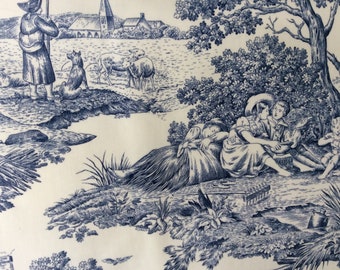May include: A blue and white toile fabric depicting a rural scene with a shepherd, sheep, a dog, and a group of people relaxing under a tree. The fabric has a vintage feel and would be ideal for upholstery, curtains, or other home decor projects.