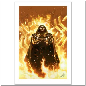 May include: A framed print featuring a comic book illustration of Doctor Doom. The character is depicted in a dark green cloak and metallic armor, standing in front of a fiery, orange background. The artwork has a dynamic, action-oriented style.