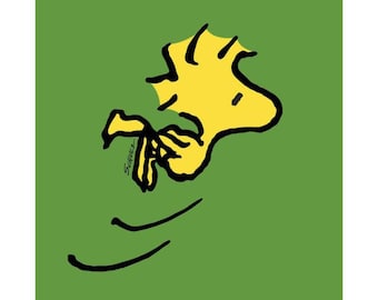 May include: A yellow cartoon bird with black outlines flying against a green background. The bird is facing right and has its wings spread out. The bird's beak is open and it appears to be singing. The word "Schnizz" is written in black cursive below the bird.