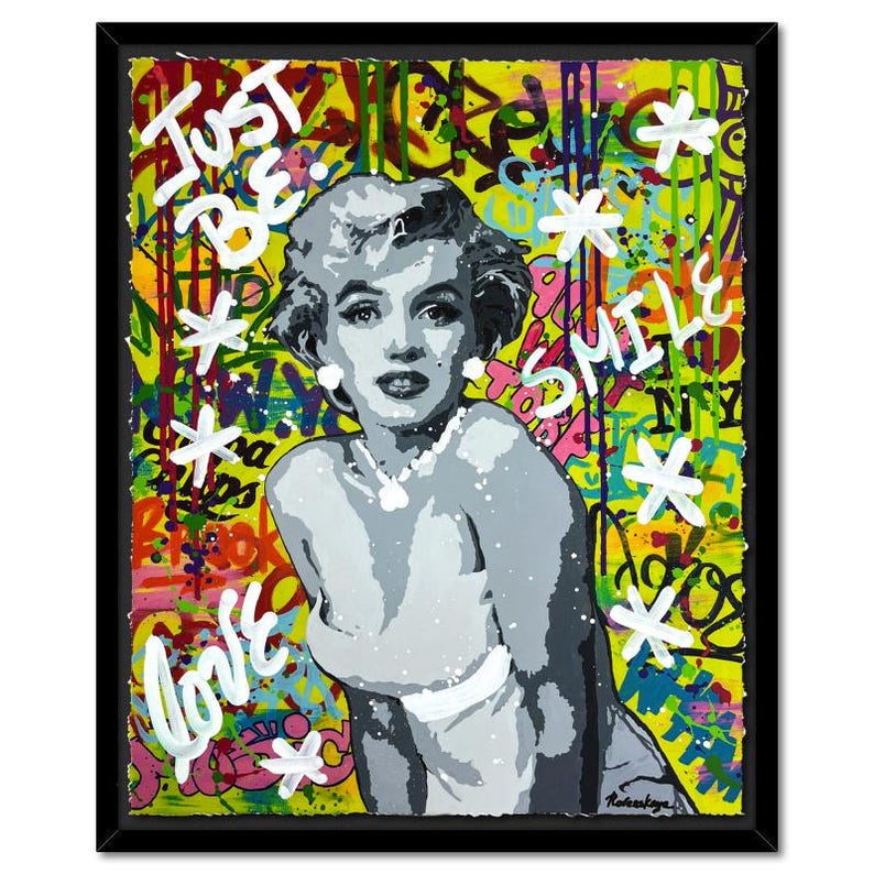 May include: A colorful and abstract painting of Marilyn Monroe with a yellow background. The painting features graffiti-style text including "Just Be", "Love", and "Smile".