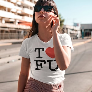 May include: White t-shirt with a black graphic that says "I ♥ FU" with a red heart.