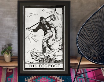 May include: Black and white illustration of a Bigfoot holding a stick and a bag. The illustration is framed in a black frame and has the text "THE BIGFOOT." at the bottom.
