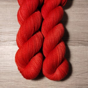 May include: Two skeins of bright red yarn, twisted together.