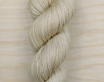 May include: A skein of natural colored yarn, wound into a loose coil.