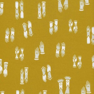 May include: Mustard-colored fabric with a repeating pattern of stylized white and gray gloves. The gloves vary in design, some with decorative cuffs and others with intricate details. The overall aesthetic is vintage or retro.