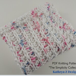 May include: White knitted dishcloth with pink and blue flecks. PDF Knitting Pattern "The Simplicity Collection" by Kathryn Z Dezign.