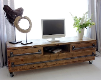 Stockton Bespoke Reclaimed Scaffolding Board Long Low Media Unit with Drawers, with dark steel pipe handles, and an Open Aperture on Castors