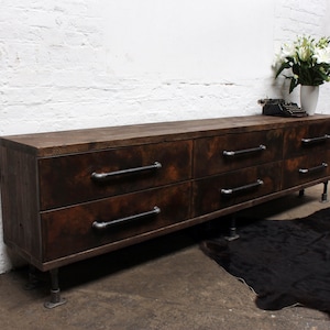 Alex Walnut Stained Reclaimed Scaffold Board Six Drawer Unit with Patinated Steel Front Drawers on Dark Steel Legs and Feet.