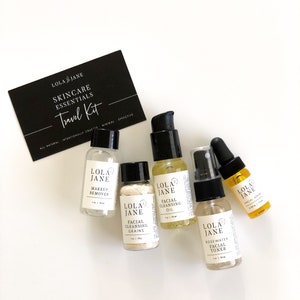 May include: A skincare travel kit with six small bottles and a black card. The bottles contain makeup remover, facial cleansing grains, facial cleansing oil, rosewater facial toner, and facial serum. The card reads "LOLA JANE SKINCARE ESSENTIALS Travel Kit."