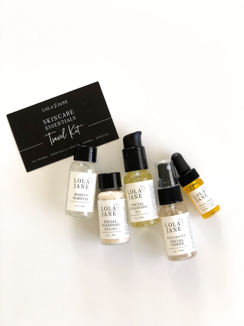May include: A skincare travel kit with six small bottles and a black card. The bottles contain makeup remover, facial cleansing grains, facial cleansing oil, rosewater facial toner, and facial serum. The card reads "LOLA JANE SKINCARE ESSENTIALS Travel Kit."