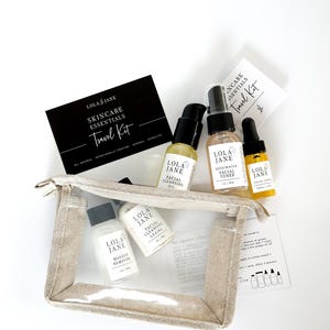 May include: A skincare travel kit with several small bottles of beauty products, including facial cleansing oil, toner, and makeup remover. The kit includes a clear, zippered pouch and a black card that reads "Skincare Essentials Travel Kit."