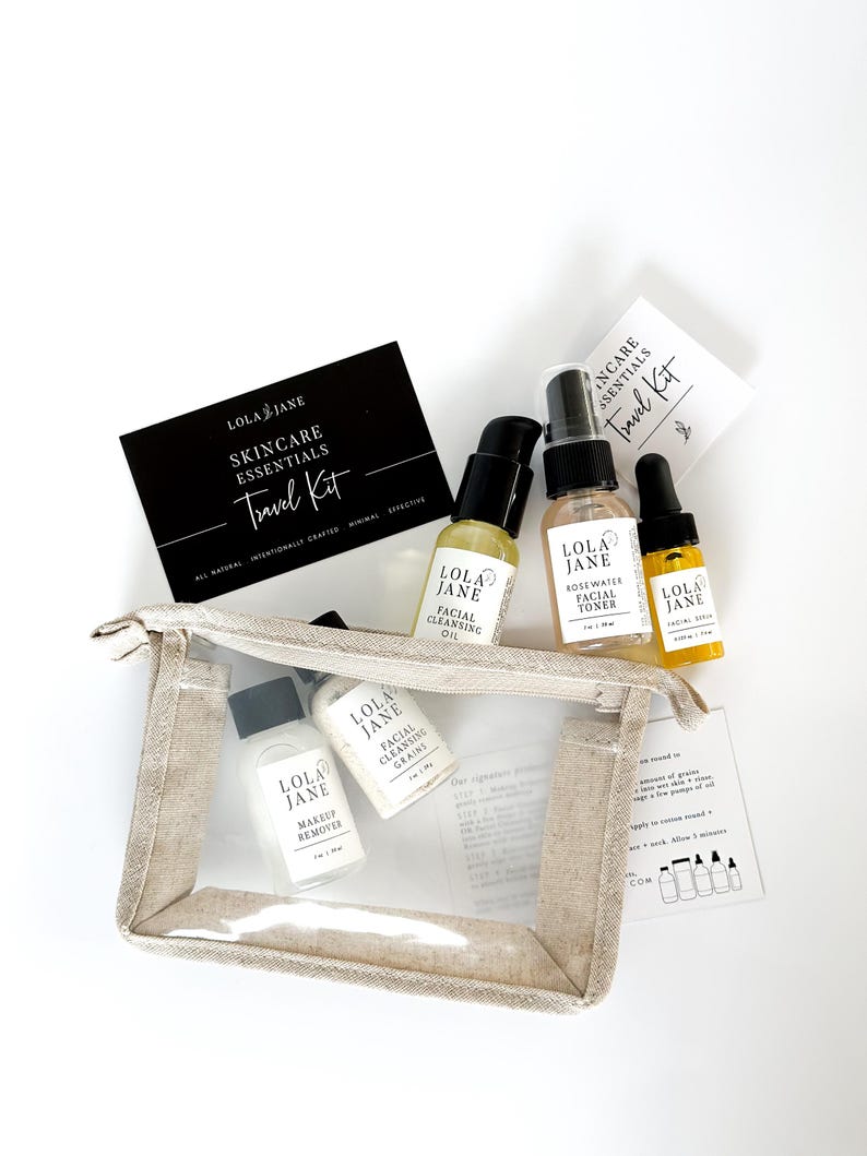 May include: A skincare travel kit with several small bottles of beauty products, including facial cleansing oil, toner, and makeup remover. The kit includes a clear, zippered pouch and a black card that reads "Skincare Essentials Travel Kit."