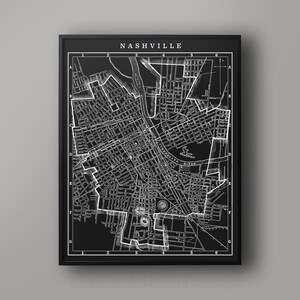 May include: Black and white map of Nashville, Tennessee. The map shows the city's streets, landmarks, and neighborhoods. The map is framed in a black frame.