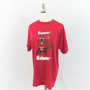 May include: Red t-shirt featuring a cartoon beaver holding a basketball. The beaver is brown with a white shirt and black shorts. The words "Beaver Believer" are printed above and below the beaver illustration.