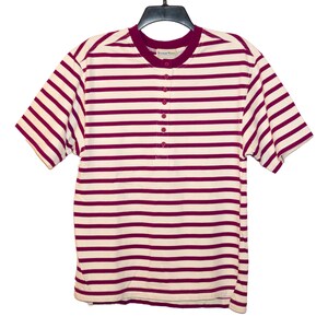 May include: A short-sleeved striped shirt with a button-up collar. The shirt is white with horizontal burgundy stripes.