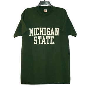 May include: A dark green t-shirt with white lettering that reads "MICHIGAN STATE".