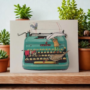 May include: A teal-colored typewriter illustration with whimsical details. A mouse, bird, and insect are depicted interacting with the typewriter. The text "Thank you," is visible on the paper. The artwork is set against a backdrop of potted succulents.