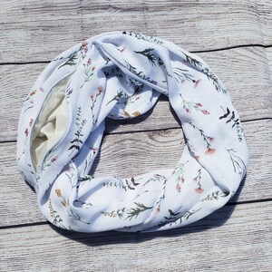 Dainty stems of wildflowers in various colors on a creamy white background with a hidden zippered pocket.