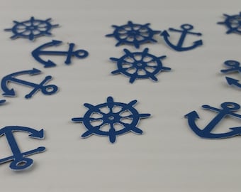 May include: Blue nautical themed paper confetti with anchors and ship wheels.