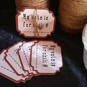 May include: A set of white and brown paper tags with the text "My vote is for chili #" printed on them. The tags are tied together with twine.