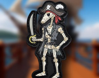 May include: A cartoon patch depicting a skeleton pirate, complete with a black hat, red bandana, and a cutlass. The pirate is wearing a black coat, set against a blurred background of a ship and ocean.
