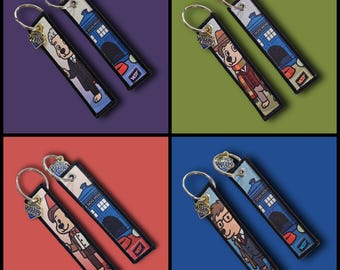 May include: Four keyrings featuring cartoon characters and the TARDIS from Doctor Who. Each keyring has a metal ring and a fabric tag with a character illustration and the text "DOG WHO". The background colours are purple, green, red, and blue.
