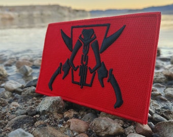 May include: Red embroidered patch featuring a black silhouette of a skull with crossed swords. The skull has a chain around its neck and a crown on its head.