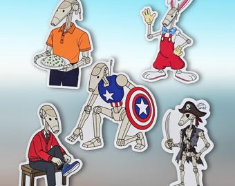 May include: A set of five cartoon robot stickers. One robot is in an orange polo shirt, carrying a plate of food. Another is dressed as a superhero with a shield. Other robots are dressed as a pirate, a person in a red sweater, and a rabbit.