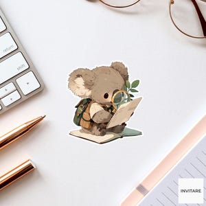 May include: A sticker illustration of a brown koala wearing a tan shirt and a green backpack, sitting on an open book while using a gold-rimmed magnifying glass to examine a piece of paper. The koala has large ears and dark eyes.