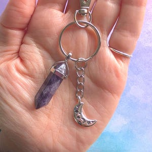 May include: A set of three ceramic mugs with a speckled, matte finish in cream, light grey, and dark grey. Each mug has a simple, modern design and a rounded handle.