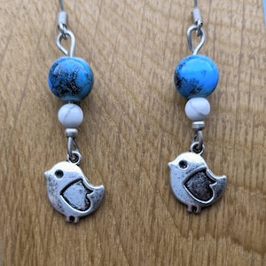 Turquoise blue agate bead silver tweet bird earrings. Stainless steel hooks.
