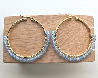 Natural blue apatite stone beads wire wrapped in gold stainless steel hoops.