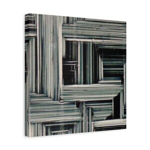 May include: Abstract canvas art featuring a geometric design with a layered, textured appearance. The artwork showcases a pattern of intersecting lines in shades of gray and black, creating a sense of depth and complexity. The canvas is stretched and ready to hang.