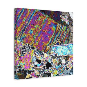 May include: A canvas print featuring a close-up of a mineral sample under polarized light. The image displays vibrant colors, including purple, yellow, blue, and green, with a crystalline structure. The artwork showcases the intricate details of the geological formation.