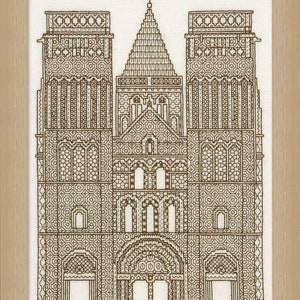 May include: A brown and white cross-stitch embroidery of a church building with a pointed roof and two towers. The building is decorated with intricate geometric patterns.