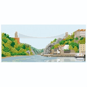 Peut inclure: Motif de point de croix représentant un paysage avec un pont suspendu enjambant une rivière. Des arbres verts luxuriants et des falaises rocheuses bordent l'eau, avec des bâtiments et un bateau à droite. Le ciel est bleu clair.